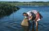 Fisherwoman with traditional fish trap, Marituba 